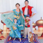 Family dressed in Aladdin Disney costumes for Halloween: Jasmine, Aladdin, Genie, and Jafar posing outdoors.