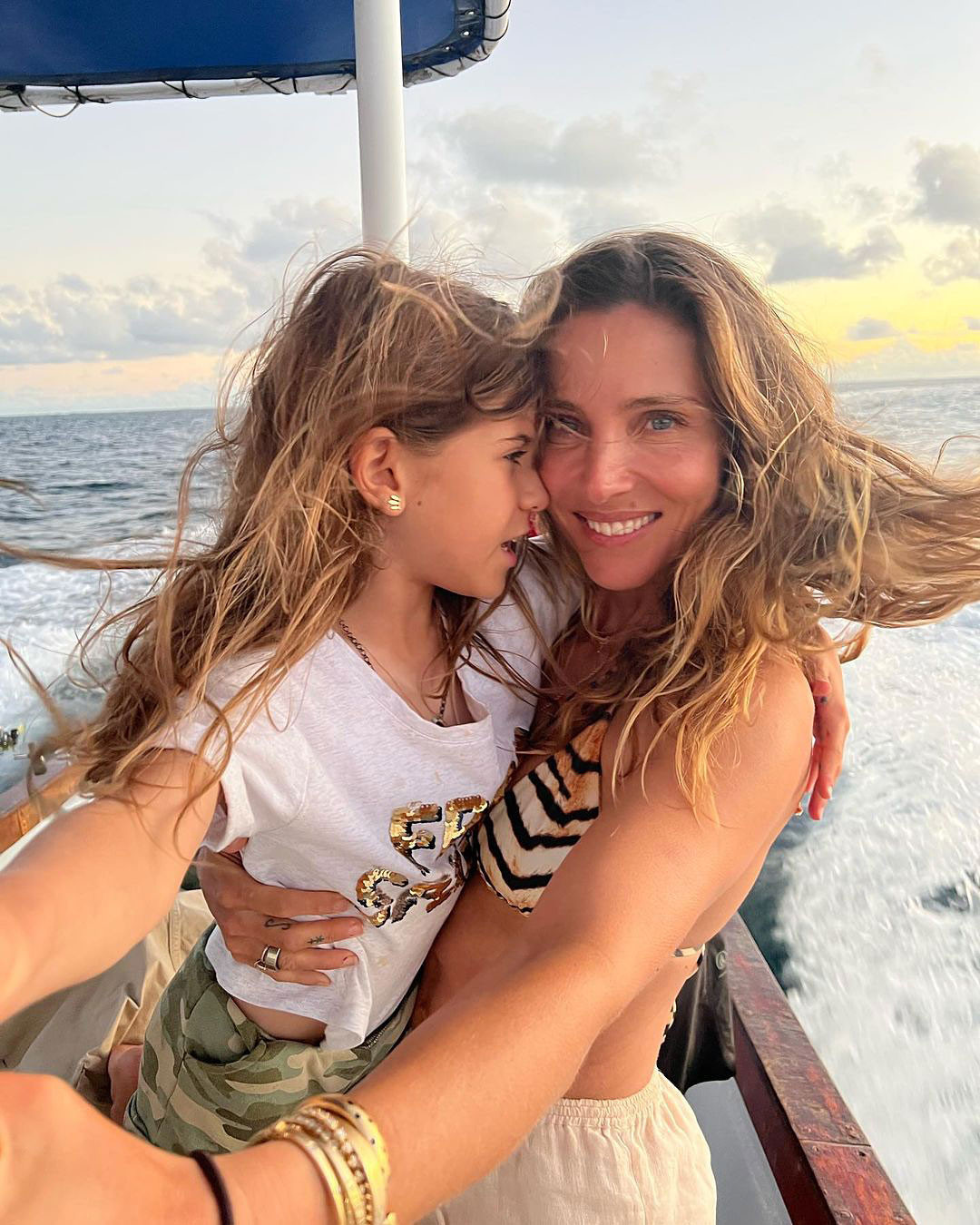 Elsa Pataky and daughter India on a boat ride during a vacation, capturing a mother-daughter bonding moment.