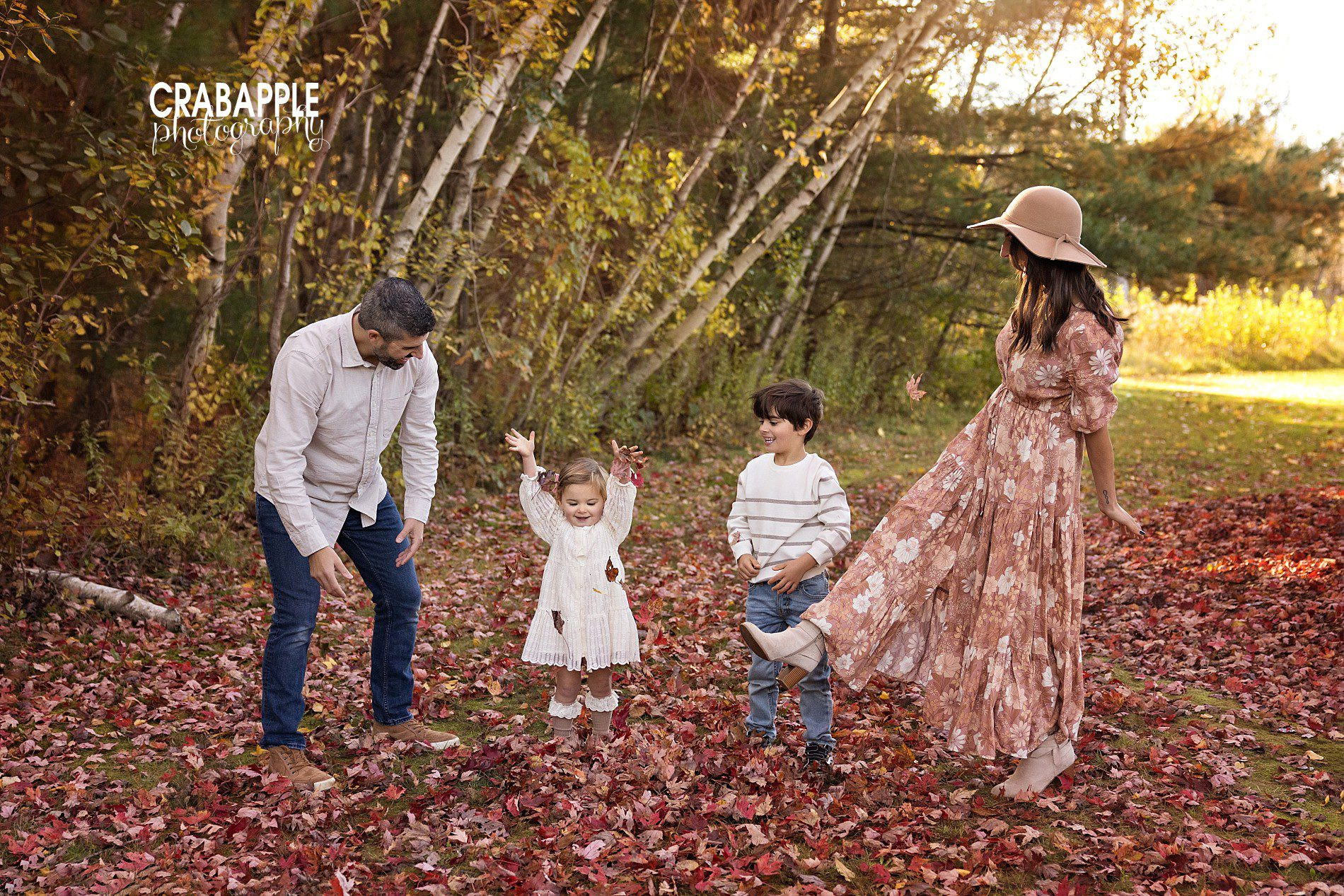 Family photos playing in fall leaves