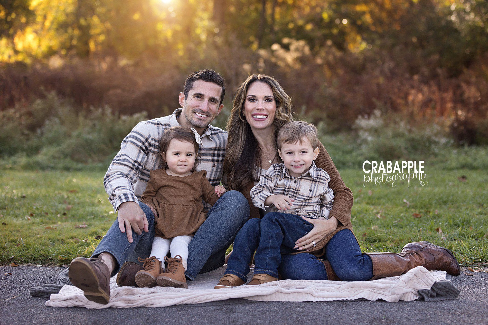 Fall family photo sitting pose with warm blanket