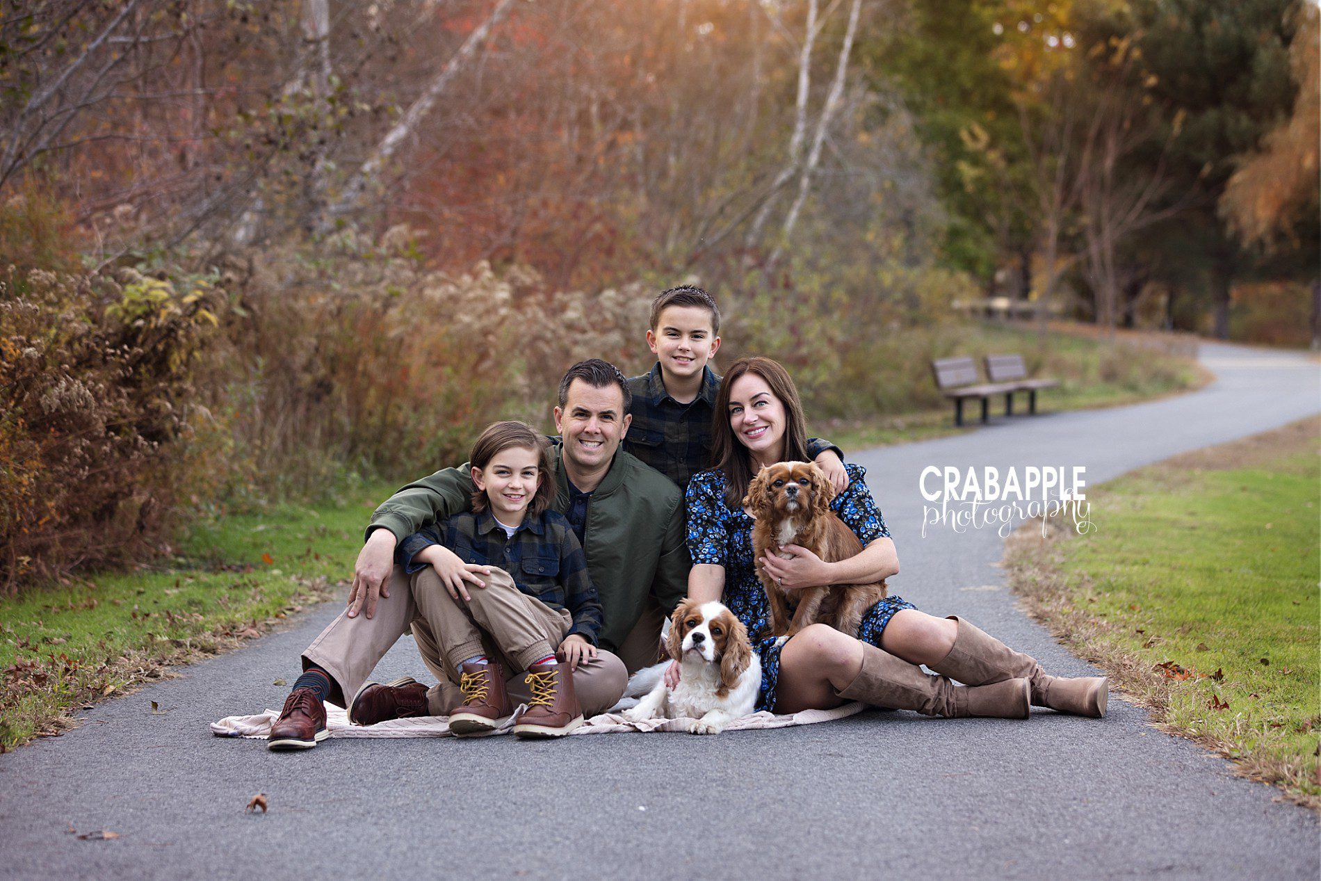 Fall family photos with dogs in a sitting pose