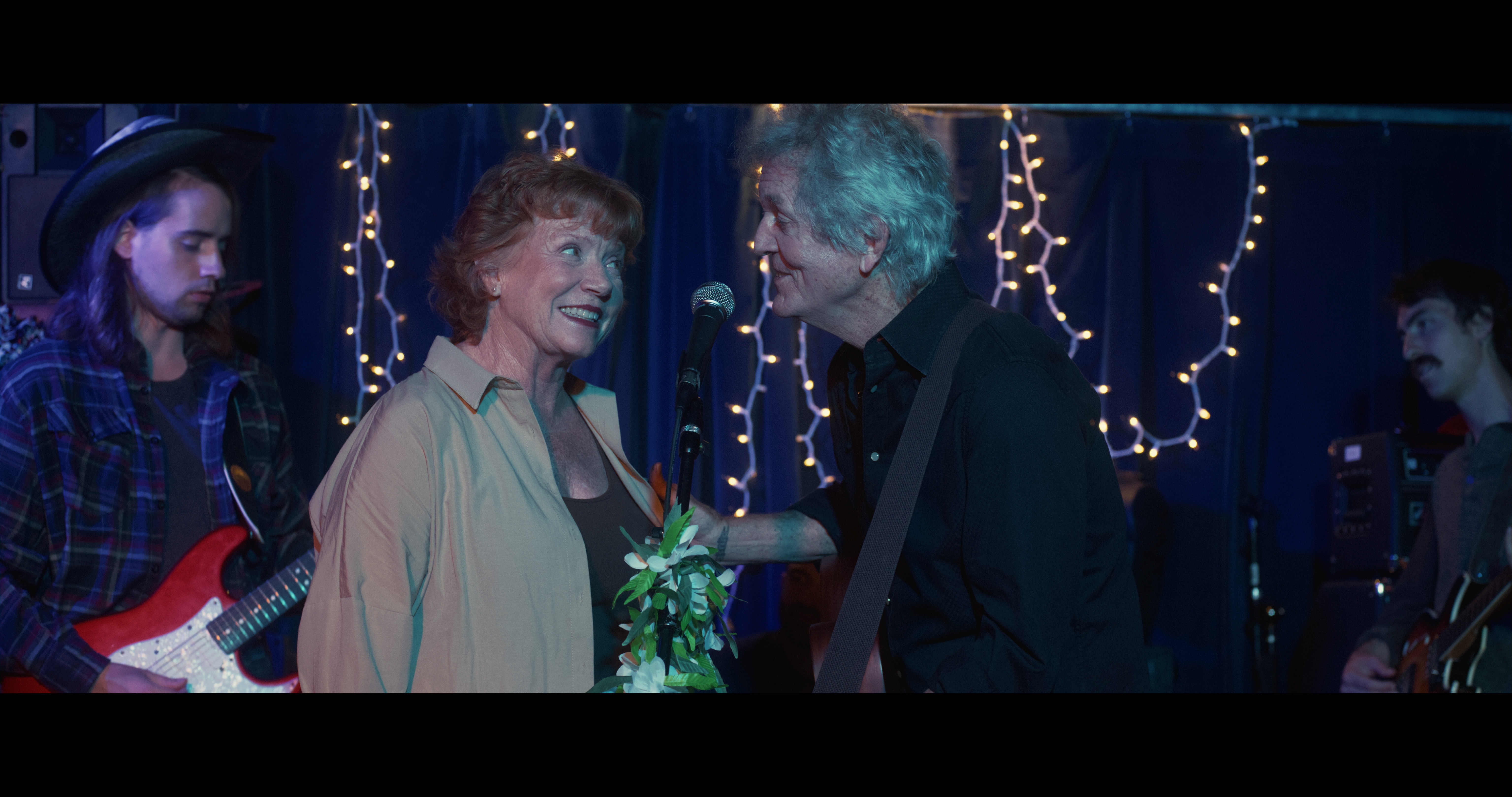 Becky Ann Baker and Rodney Crowell in &quot;All Happy Families&quot; movie, a scene featuring music and performance at a Chicago bar location.