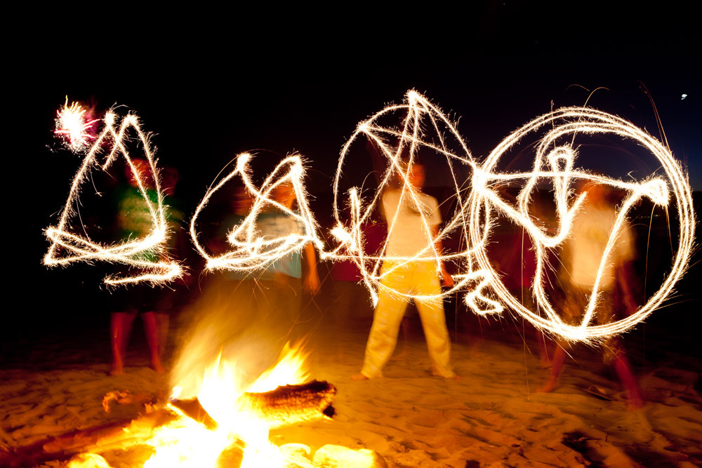 Family dance party with sparklers at a reunion bonfire