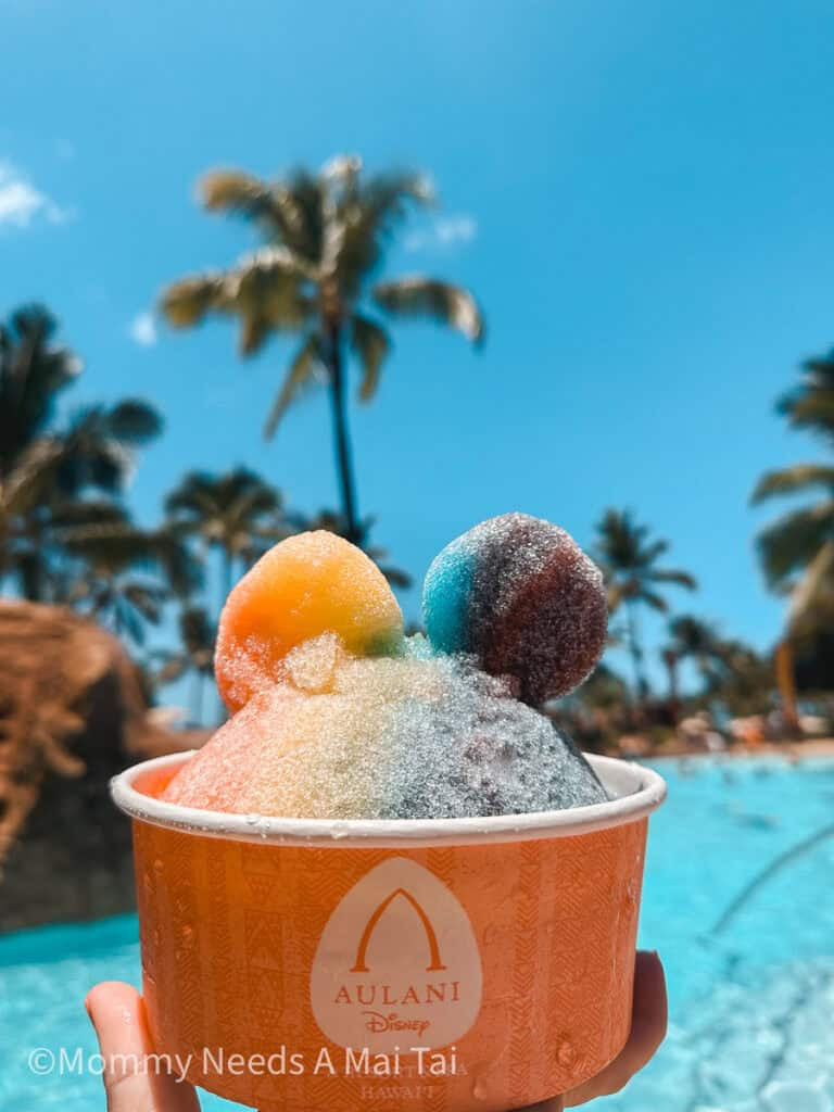 Rainbow Mickey Mouse Shave Ice with palm trees at Aulani Disney Resort on Oahu.