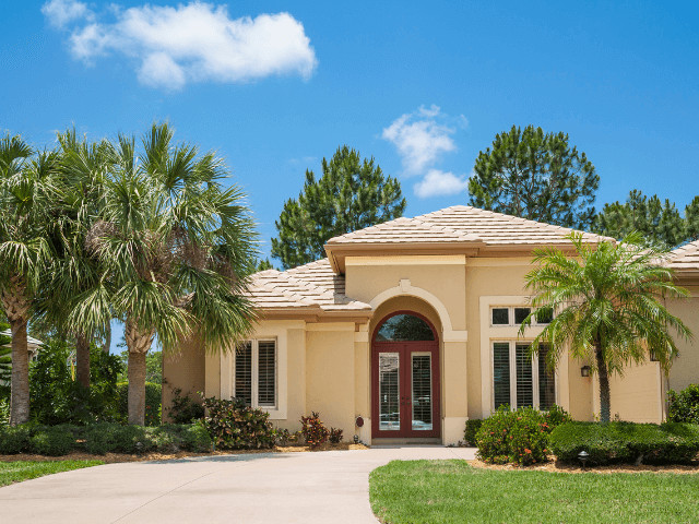 Family home in Niceville, Florida, with a well-kept lawn and trees, portraying a safe and family-oriented suburban environment in the Panhandle