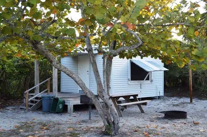 Exterior view of a Cayo Costa Cabin nestled among trees