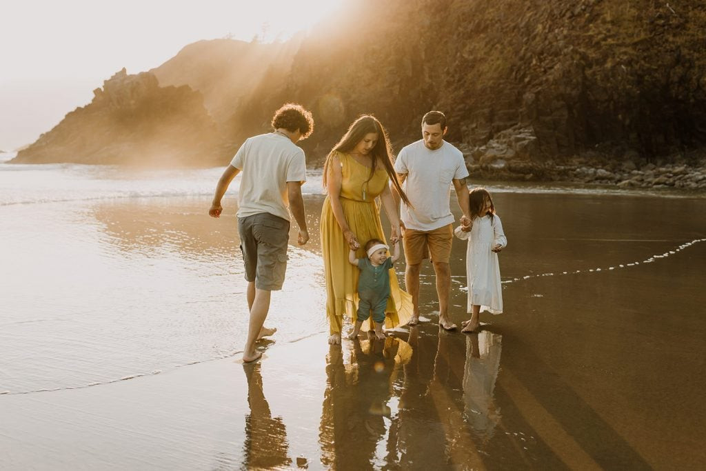 family playing at the beach