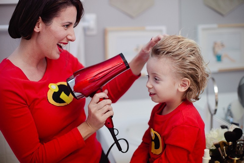Detailed shot of the DIY Incredibles logo made of felt, illustrating the homemade emblem on a family member's costume.
