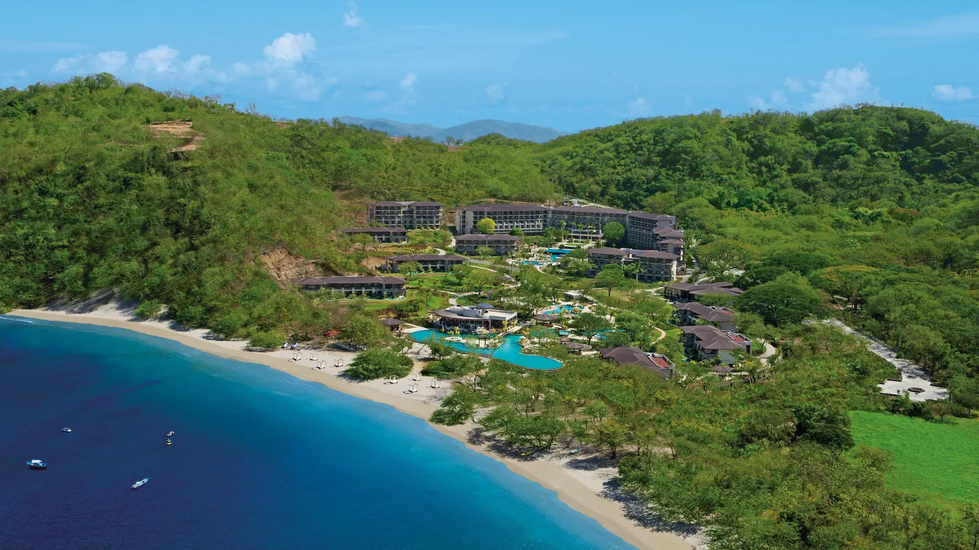 Family-friendly pool and waterslides at Dreams Las Mareas Costa Rica, a popular all-inclusive resort.