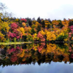 Family enjoying the stunning fall colors at Indian Lake in the Adirondacks