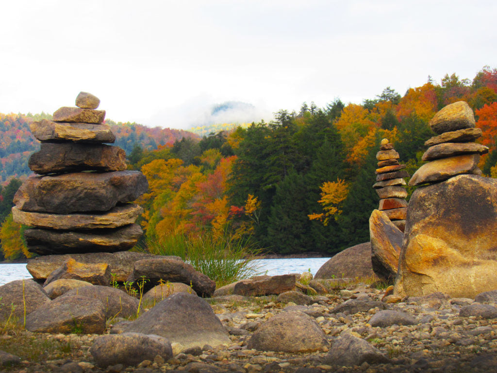 Building rock cairns together as a relaxing and meditative family activity during camping