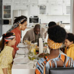 family sitting around a dining table for a dinner