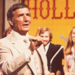 Richard Dawson, the original host of Family Feud, smiling warmly on set.
