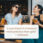 Two women laughing together over drinks, embodying the joy of friends who are like family, reflecting friends are family quotes.
