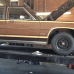 Front passenger side view of the original 1984 Ford LTD Country Squire wagon before conversion.