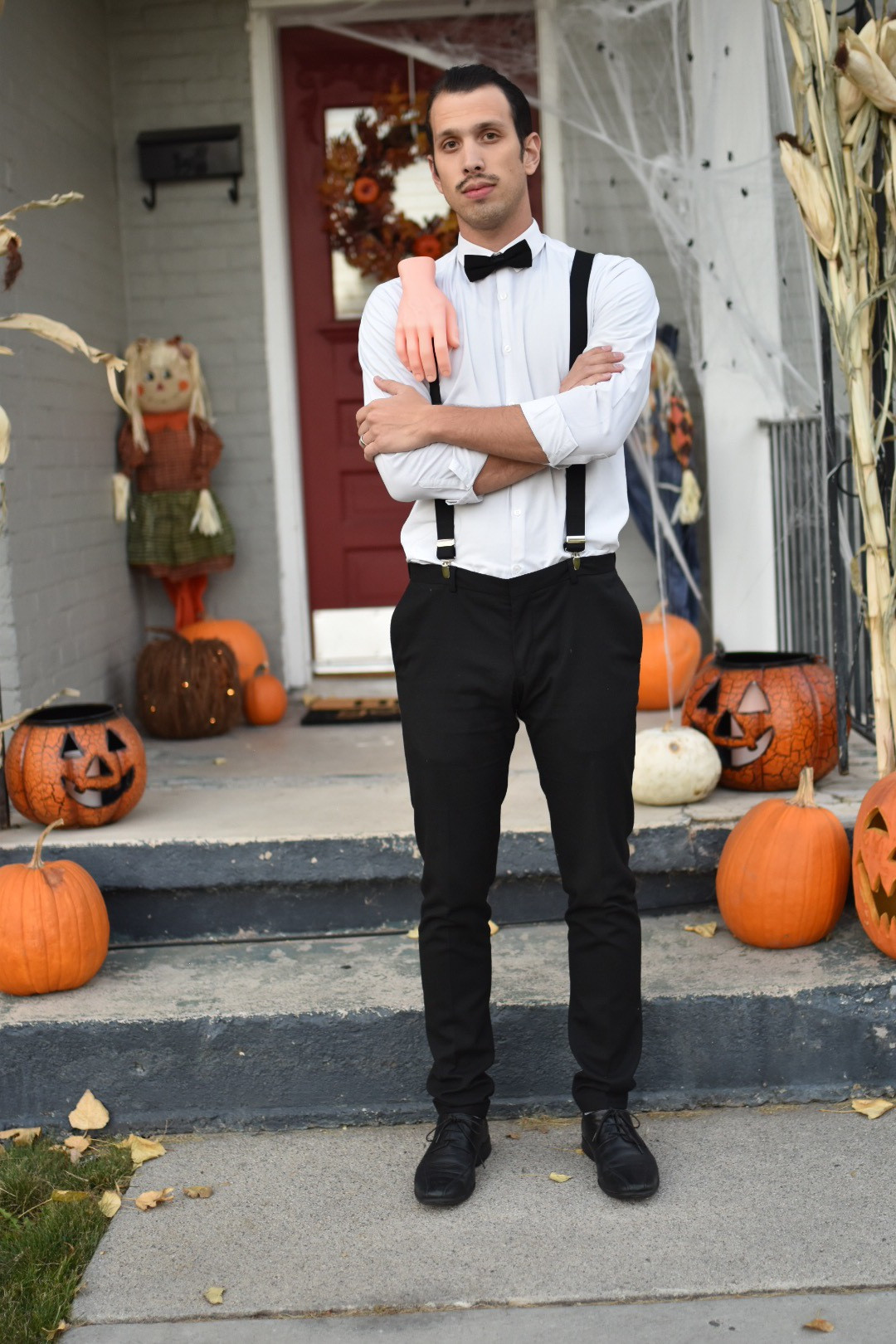 Iconic 'Thing' detail on a Gomez Addams costume, attached to suspenders for a fun and recognizable Halloween accessory.
