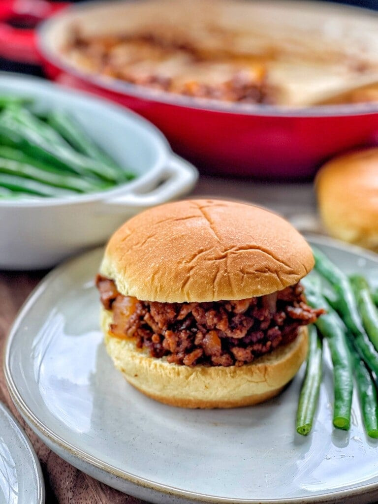 A classic sloppy joe sandwich, showcasing its saucy filling and inviting presentation on a bun.