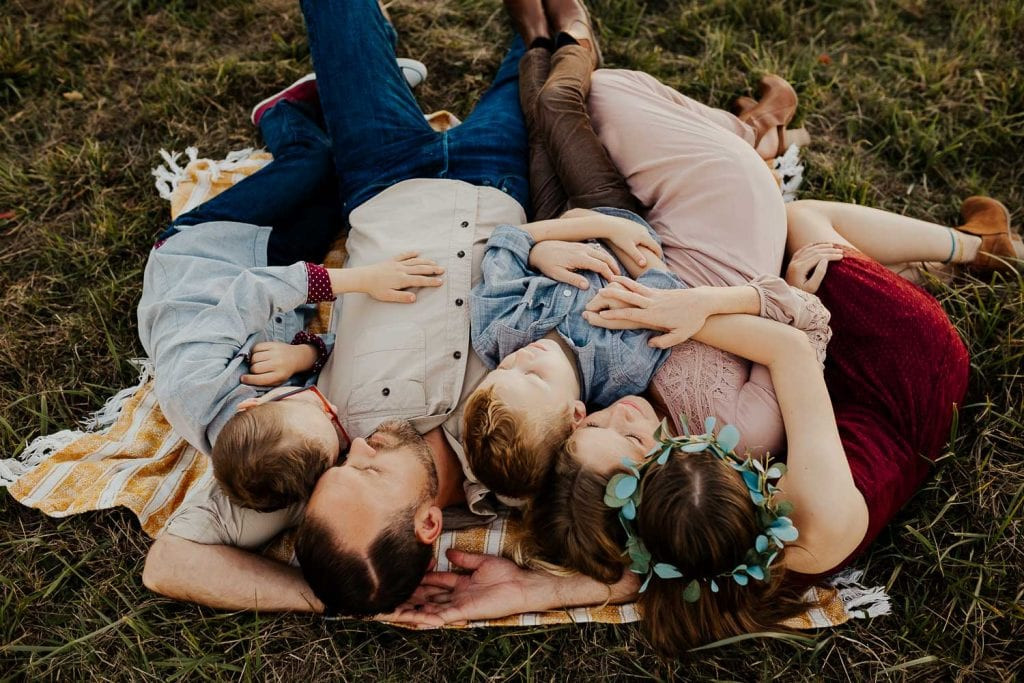 Family laying on a blanket together