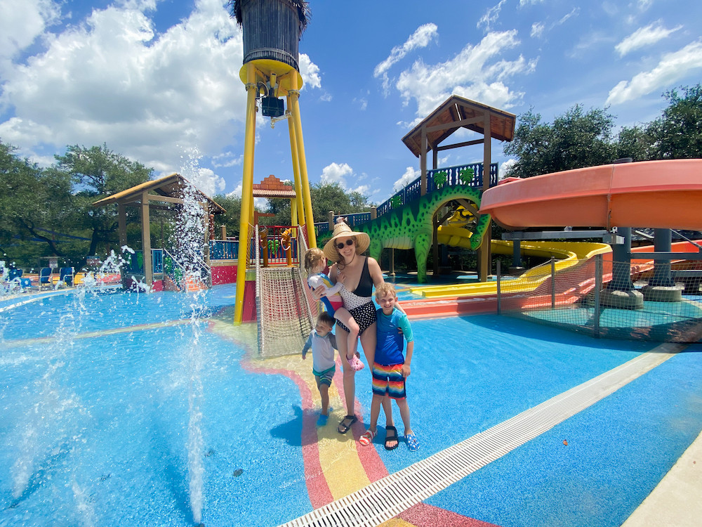 Kids enjoying water slides Jellystone Park Texas, family water park fun Texas, Texas Hill Country family resorts, camping with kids in Texas, Jellystone Park Canyon Lake water activities, family summer vacation ideas Texas, water park resorts for families, Texas family travel guide, family-friendly Texas campgrounds, summer trips in Texas,