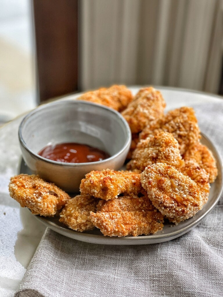Two images of homemade baked chicken nuggets, showcasing their golden-brown and crispy texture.