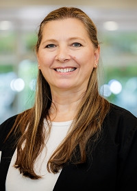 Darcy smiling in office
