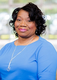Eunice smiling in office