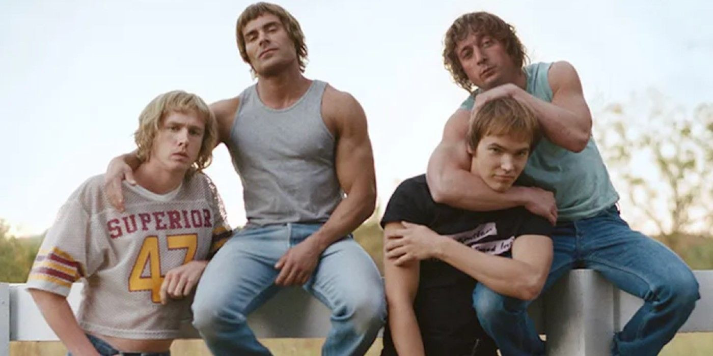 A behind-the-scenes image from the set of The Iron Claw movie, showing the actors portraying the Von Erich brothers in wrestling gear, capturing the intensity and drama of their story being brought to life on screen.
