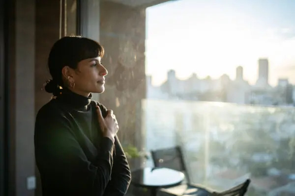 Woman thoughtfully looking out a window, representing seeking clarity in divorce