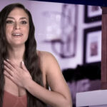 Sammy doing a diary room session in Jersey Shore: Family Vacation, hand to her chest smiling.