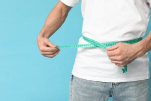 man measuring waist