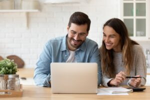man-woman-happy-looking-at-computer