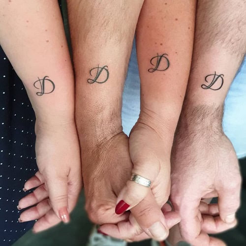 Matching family symbol tattoos on wrists