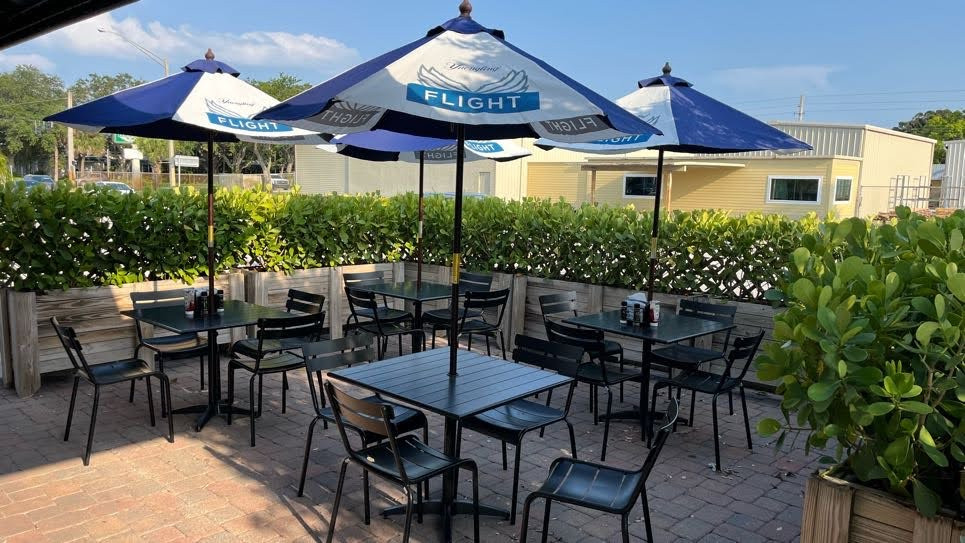 Outdoor patio seating at Nick's Family Restaurant, offering a pleasant al fresco dining experience in Vero Beach.