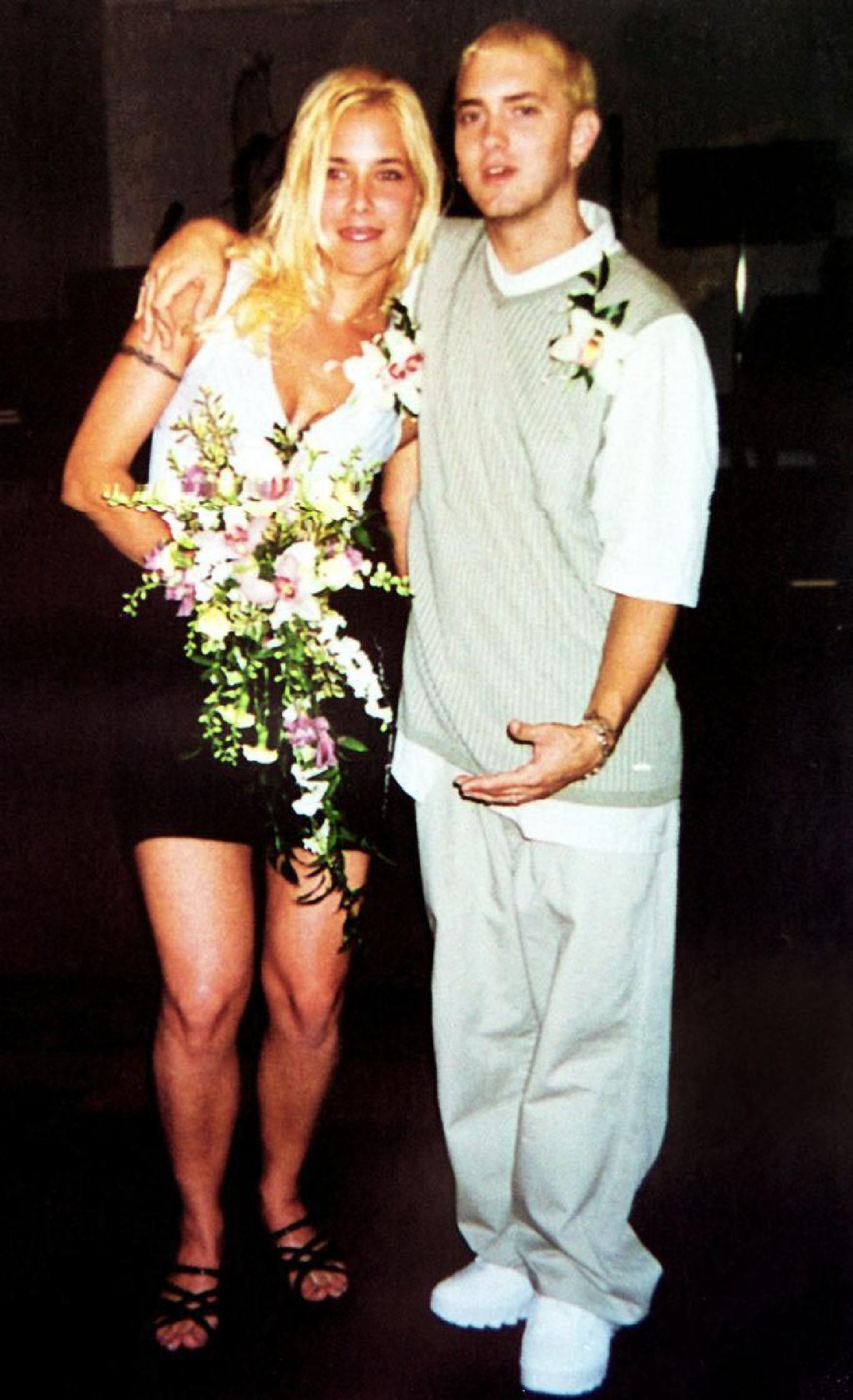 Eminem and Kim Scott during their wedding, capturing a moment in their tumultuous relationship history