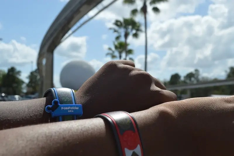 Disney annual passholder card against a colorful park backdrop