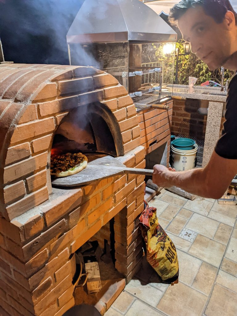 Family cooking pizza in an Airbnb kitchen