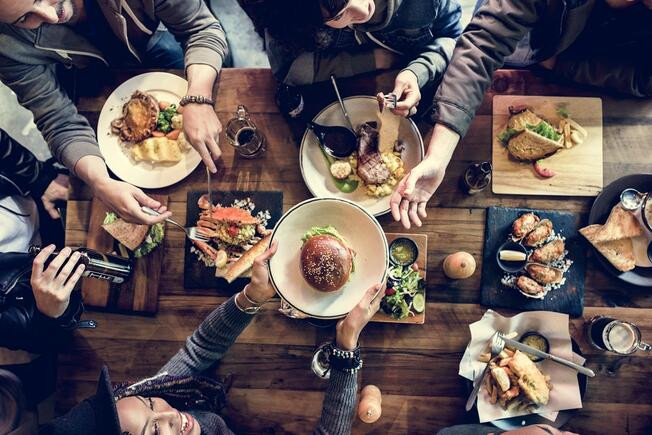 A beautifully set table at a family style restaurant, showcasing a variety of dishes perfect for sharing and communal dining.