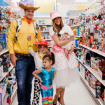 Family of 5 Halloween costumes: The Hudson family dressed as Toy Story characters Woody, Jessie, Barbie, Bo Peep, and a lamb for a themed Halloween.
