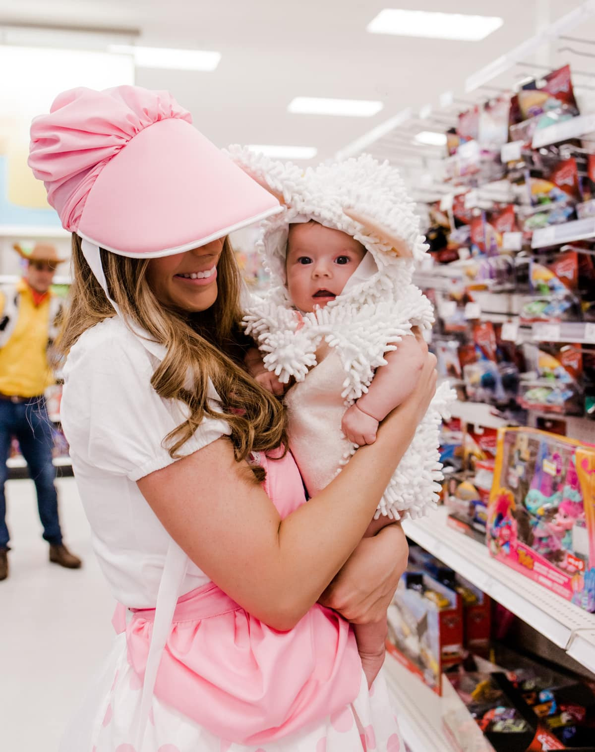 Newborn Halloween costumes idea: Baby dressed as a fluffy lamb, part of a family of 5 Toy Story themed costumes.