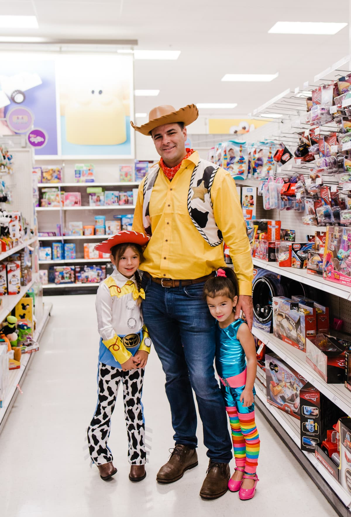 Best family Halloween costumes: Dad dressed as Woody and daughter as Jessie from Toy Story, a cute duo for a family of 5.