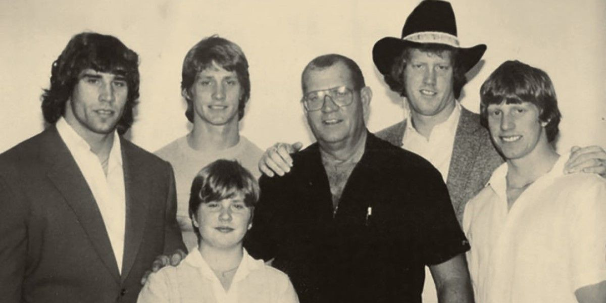 The patriarch of the Von Erich wrestling family, Fritz Von Erich, standing proudly in a wrestling ring, showcasing his powerful physique and commanding presence.