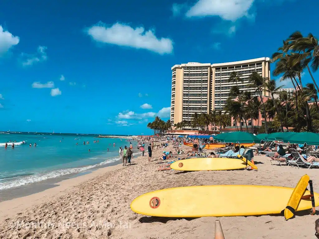 Surfboards laying on the sand at Waikiki Beach, Oahu on a sunny day.