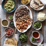 Family Style Taco Bar with various meats, toppings and salsas