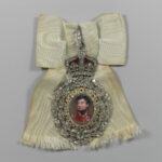 Royal Family Order of King George IV, showcasing the jeweled portrait and ivory ribbon