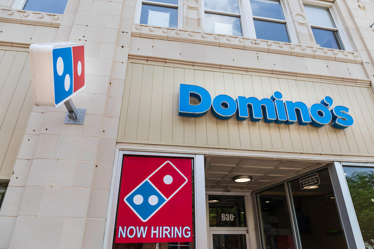 The storefront of a Domino's Pizza, a popular destination for families seeking quick and affordable meal solutions