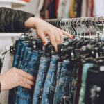 Assorted clothing on racks at Christian Family Care Thrift Store, promoting sustainable fashion and community support