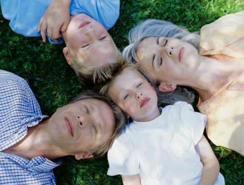Family lying on grass