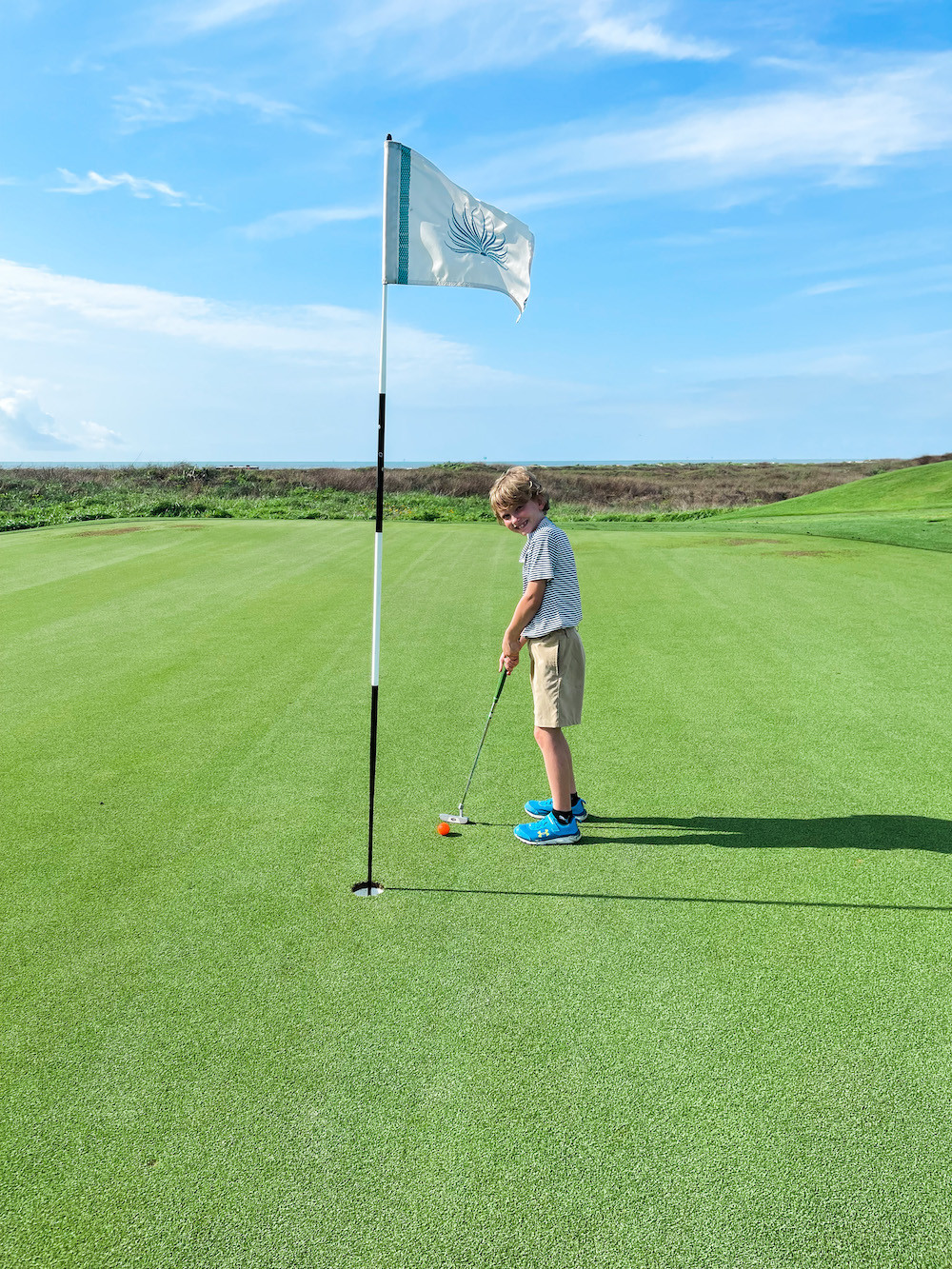 The serene beachfront at Palmilla Beach Resort in Port Aransas offers families a tranquil setting to enjoy beach activities and create lasting memories