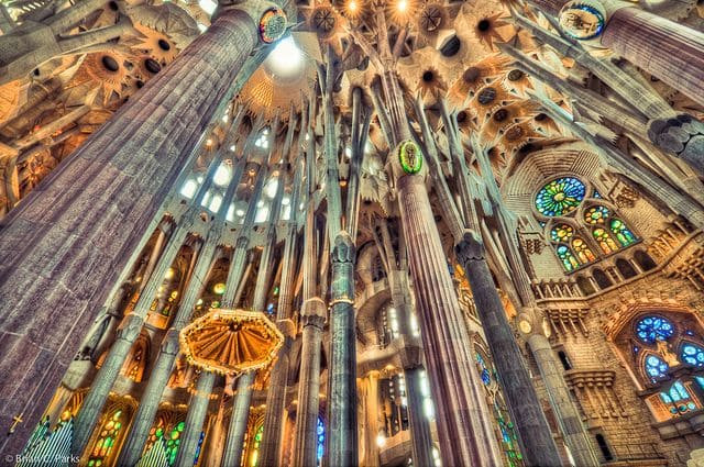 Sunlight streams through stained glass windows, creating a magical atmosphere inside Sagrada Familia Church