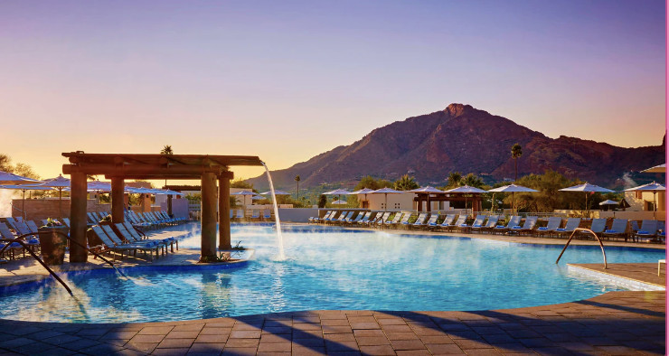 JW Marriott Scottsdale Camelback Inn Resort and Spa, Scottsdale, AZ Resort pool with water fall and poolside loungers with mountain in background